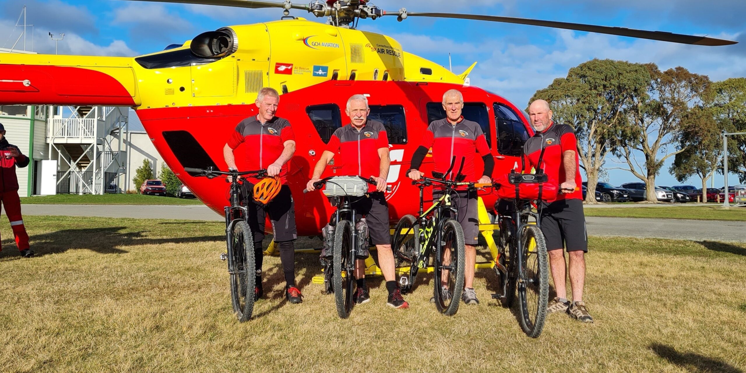 Group of cyclists in front of the rescue helicopter