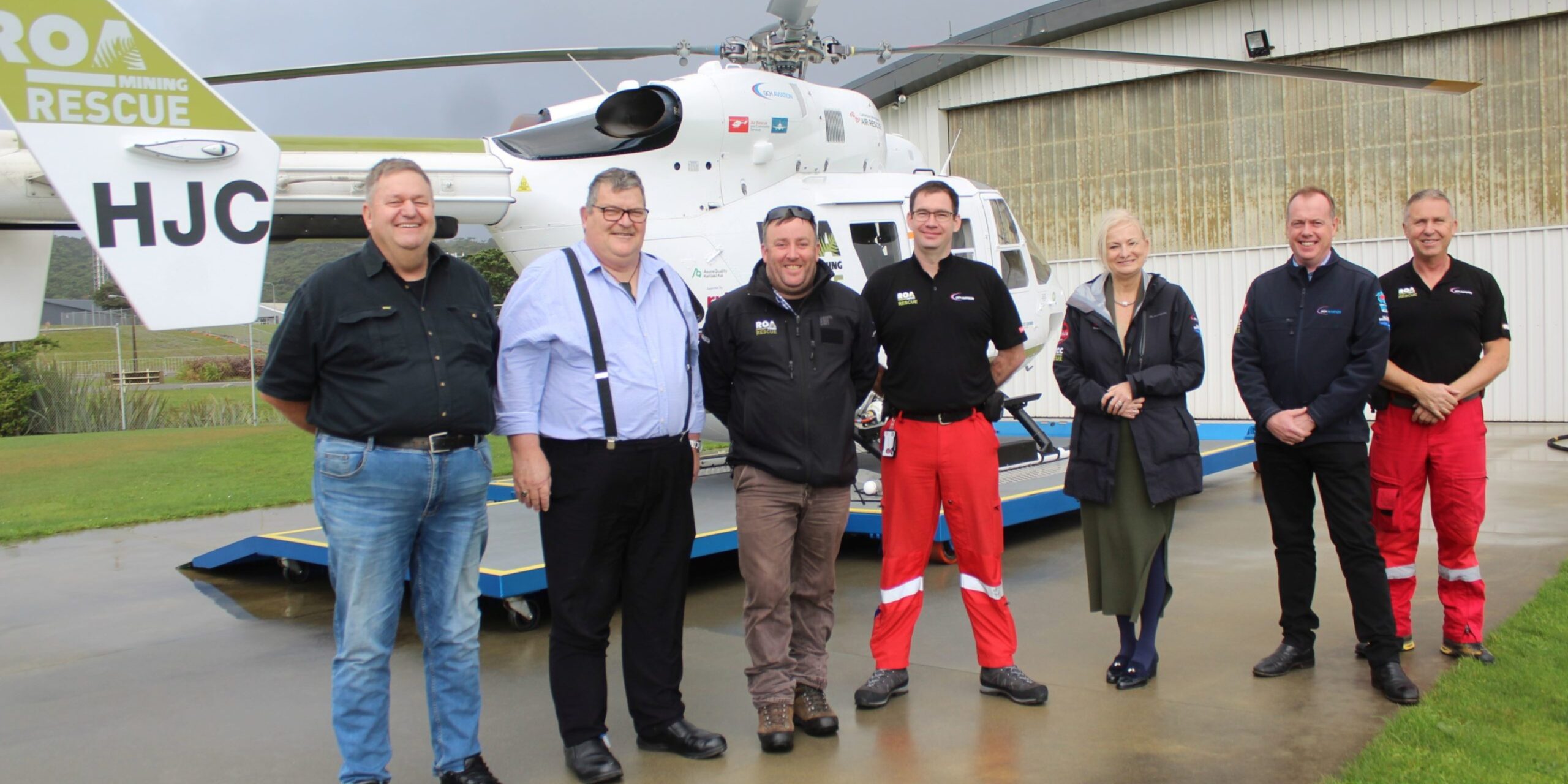 A group of west coast club representatives and crew in front of the West Coast ROA mining rescue helicopter