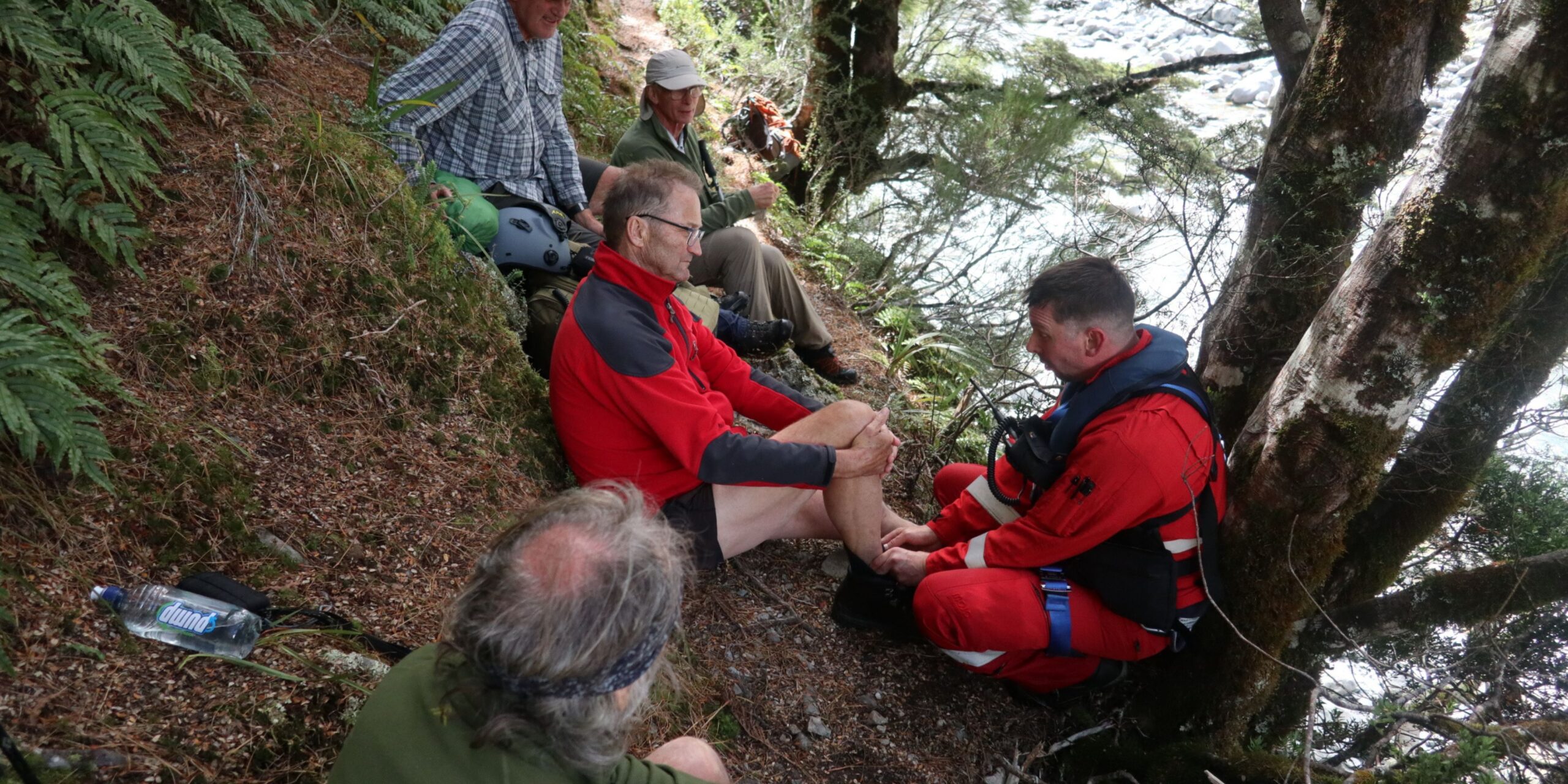 patient on a hillside being treated by a helicopter medic