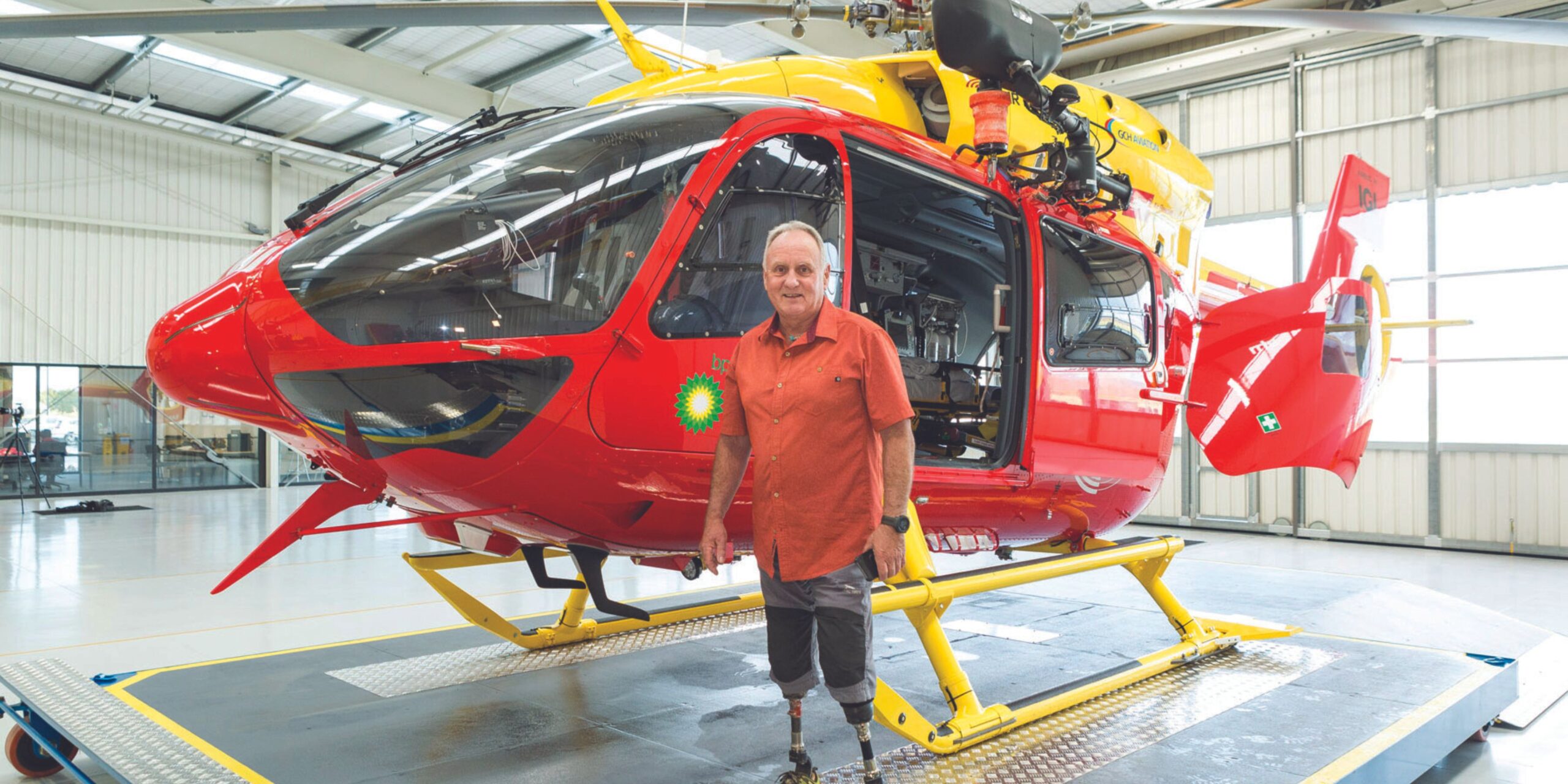 Mark Inglis standing in front of the helicopter