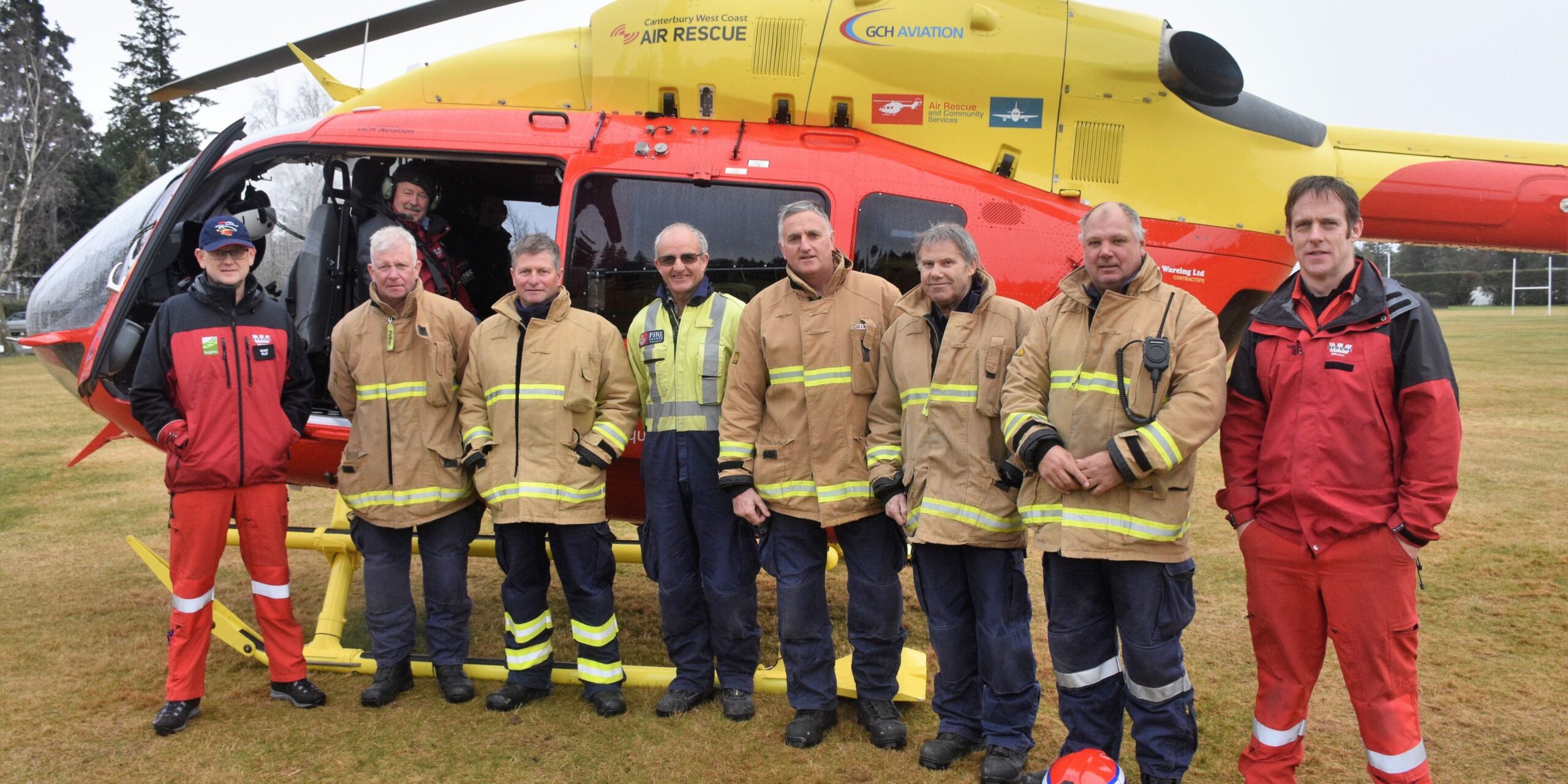 Fire service in front of the rescue helicopter
