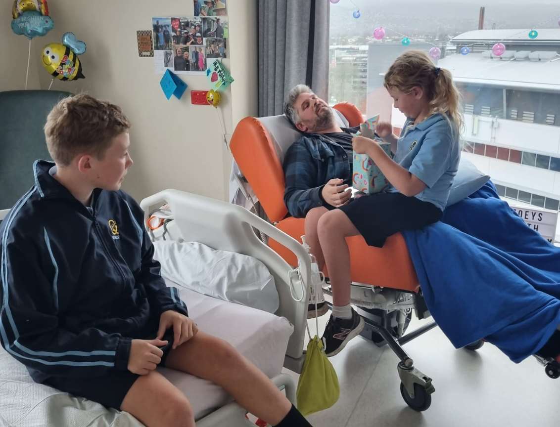 Brendan in hospital with Zoey on his lap