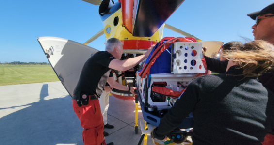 Loading the transport incubator into the Westpac Rescue Helicopter