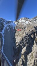 The view from the crew ... the arrow and red circle point to where Dave lay in the middle of the scree slope.