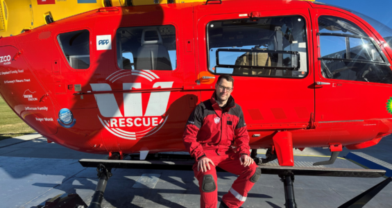 Image of Justin in front of the Westpac Rescue Helicopter